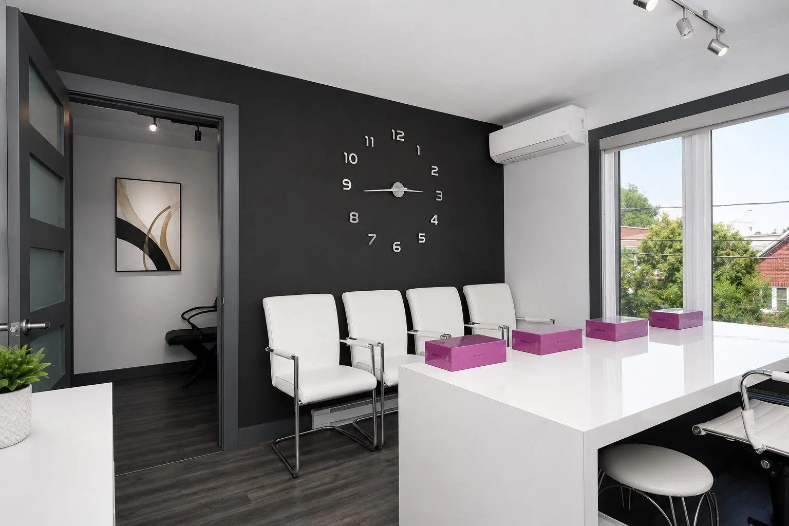 Administrative reception space: white counter, seating and designer clock