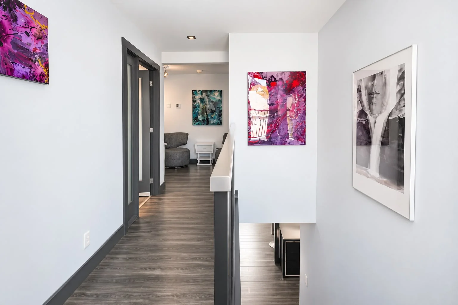 Upstairs hallway lined with a collection of original artworks