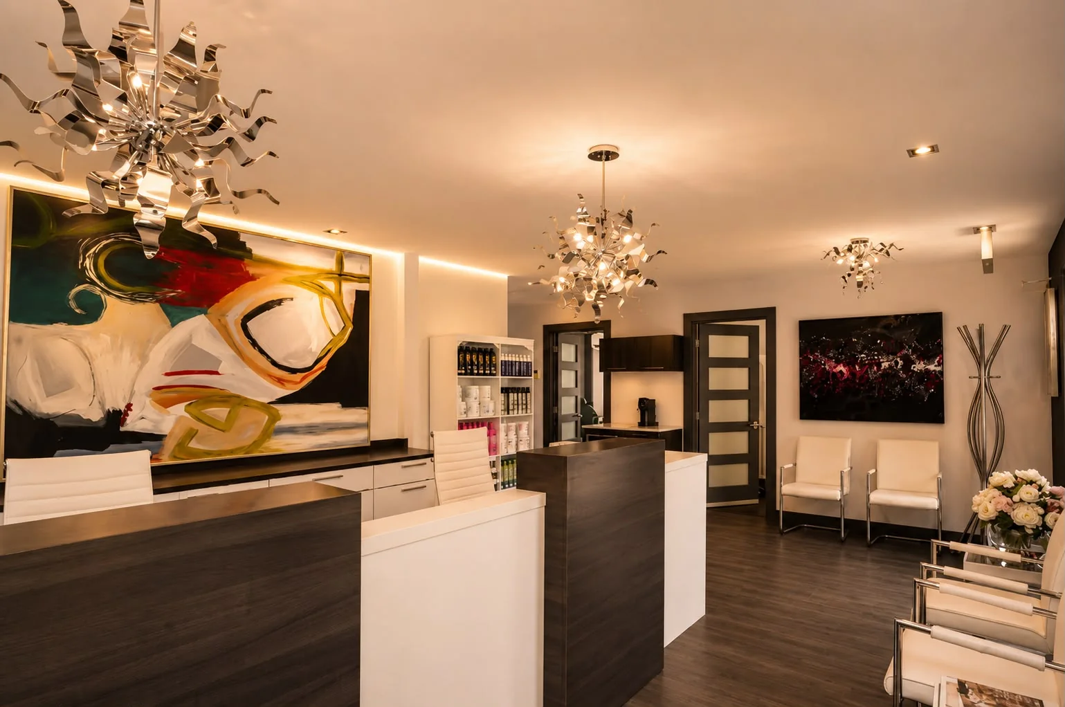 Reception area with a large contemporary artwork and warm lighting