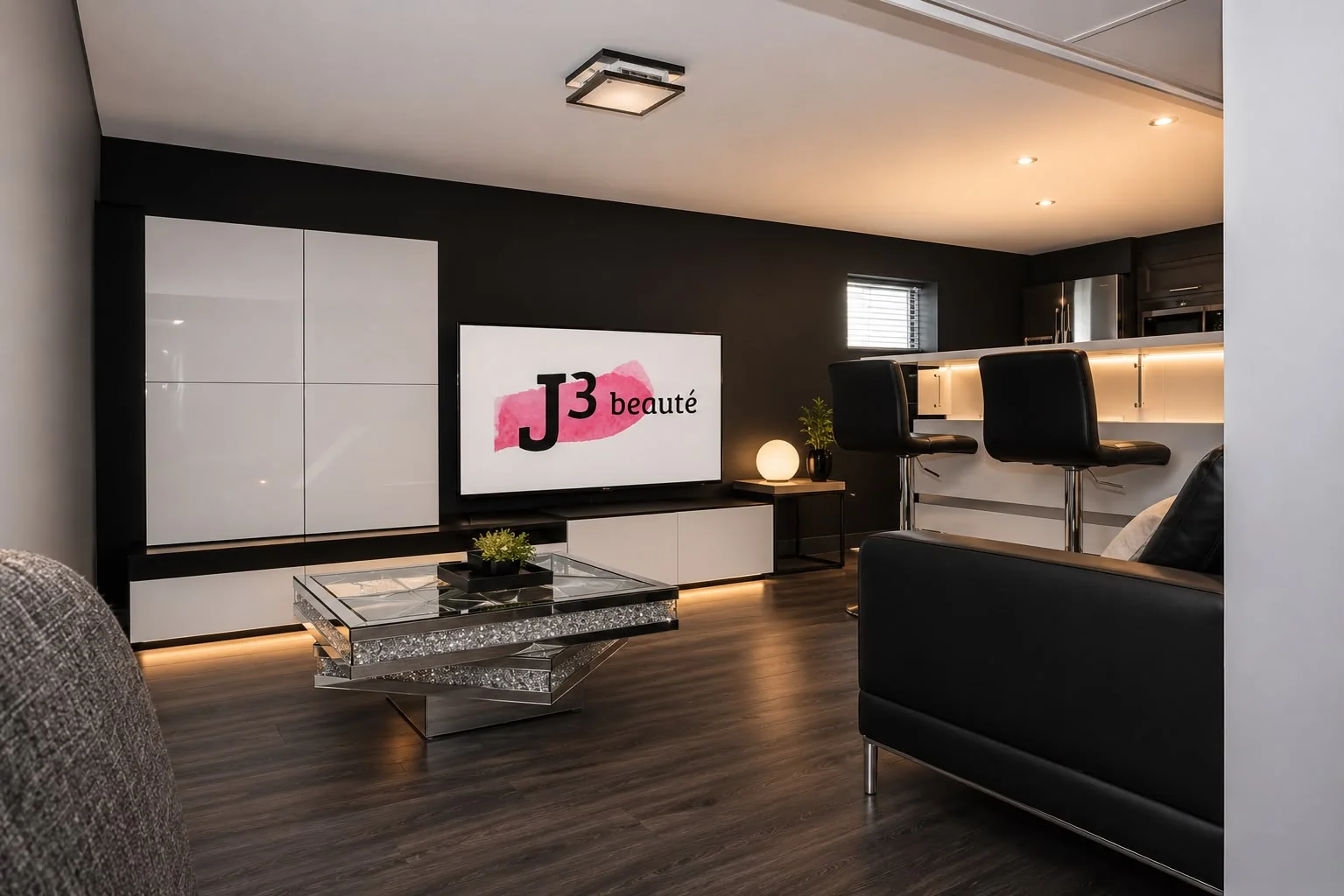 Salon de détente de l'équipe avec écran affichant le logo J3 beauté